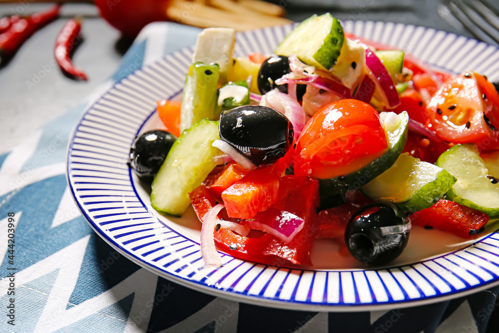 Plate with tasty Greek salad on table, closeup