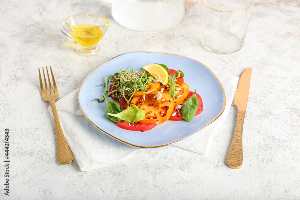 Plate with tasty tomato carpaccio and oil on light background