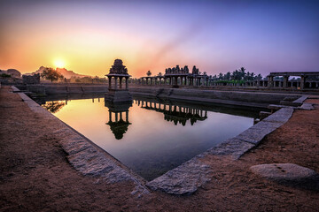 Wall Mural - View of sunrise at Pushkarni, Sri Krishna tank in ruins. Hampi, karnataka, India.