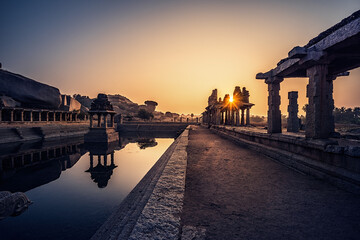 Wall Mural - View of sunrise at Pushkarni, Sri Krishna tank in ruins. Hampi, karnataka, India.