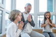 © zinkevych - Gray-haired man and his kids sitting peacefully with namaste