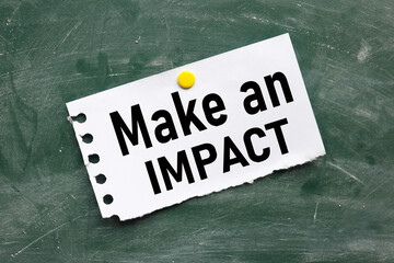 MAKE AN IMPACT, text on chalk board. black font