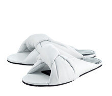 Beautiful Pair Of Snow-white Flip-flops Made Of Genuine White Leather With Crisscrossing Stripes, On A Thin Sole, Isolated On A White Background. The Trend Of The Season.