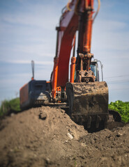 Wall Mural - Yellow heavy excavator and bulldozer excavating sand and working during road works, unloading sand during construction of the new road