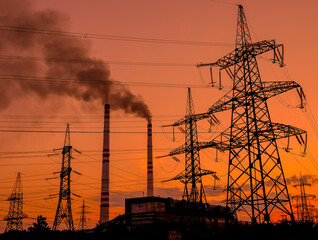 Smoke from factory chimneys at sunset