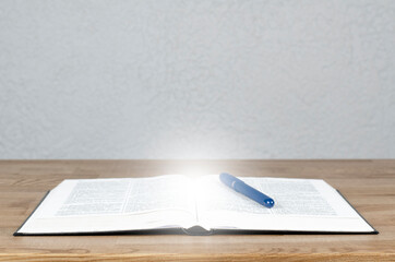 Wall Mural - Open Bible. Scripture. Pen on the table. Education and Training.