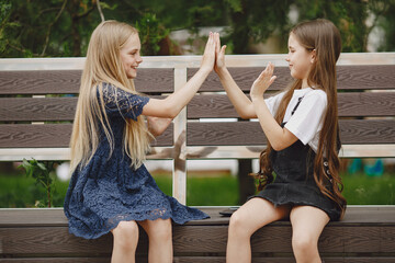 Happy children sitting together close and smile