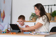 © yavdat - Mother with young boy using digital tablet.happy mom and baby play educational online games on the tablet.