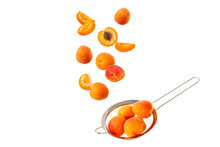 Fresh Ripe Apricot Fruits Falling In Metal Sieve Isolated On White Background. Flying Food