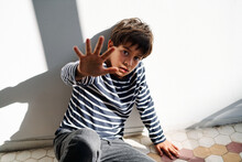 Scared Kid With Stop Gesture Suffering From Domestic Violence