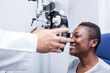© ADDICTIVE STOCK - Black woman in optometry cabinet