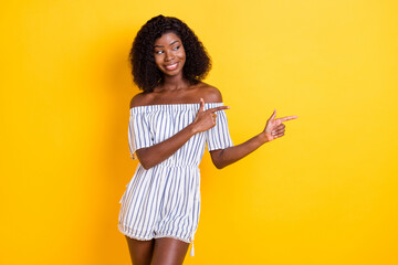 Sticker - Photo of cute sweet dark skin woman wear striped outfit looking pointing fingers empty space isolated yellow color background