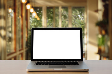 laptop on wood table.