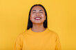 © ADDICTIVE STOCK - Cheerful ethnic woman on yellow background