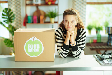 Wall Mural - happy modern housewife with food box in kitchen