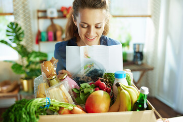 Wall Mural - smiling housewife in kitchen