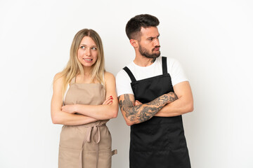 Wall Mural - Restaurant waiter over isolated white background with confuse face expression while bites lip