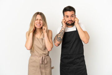 Wall Mural - Restaurant waiter over isolated white background covering both ears with hands