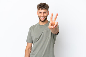 Young caucasian handsome man isolated on white background smiling and showing victory sign