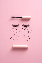 Creative Flat Lay Composition With Mascara, False Eyelashes And Confetti On Pink Background