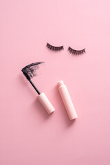 Wall Mural - Flat lay mascara with stroke and false eyelashes on pink background.