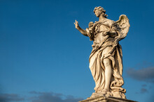 Beautiful Detail Of An Angel From The Bernini School, Castel Sant'Angelo, Vatican, From The Ponte Degli Angeli Over The Tiber, With A Clear Blue Sky After A Thunderstorm, Vatican, Rome, Italy.