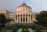 Fototapeta Miasto - Aerial drone view of The Romanian Athenaeum George Enescu (Ateneul Roman) in Bucharest, Romania. Most prestigious concert hall and one of the most beautiful buildings in the city in the sunset.