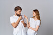© SHOTPRIME STUDIO - man and woman in white t-shirts are standing next to friendship music in headphones