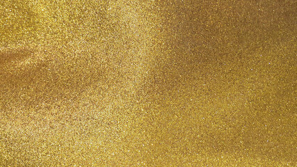 gold glitter background. abstract sparkle texture. festive or celebration concept background filled with shiny gold glitter.