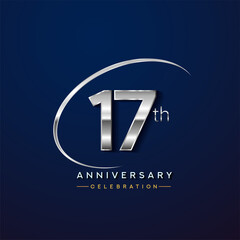 17th anniversary logotype silver color with swoosh or ring, isolated on blue background for anniversary celebration event.