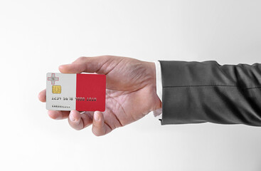 Bank credit plastic card with flag of Malta holding man in elegant suit