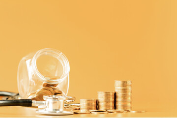 Jar bank and stack gold coins brown background in the office, Saving money for future investment concept.