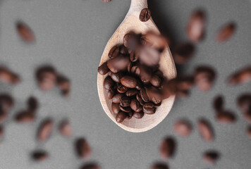 Wall Mural - Coffee in a spoon on the table. Grains of coffee in a wooden spoon on the table