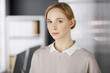 © rogerphoto - Friendly adult casual dressed business woman standing straight. Business headshot or portrait in office