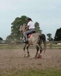  Horse riding instructor works with the horse.