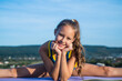 teen girl wear sportswear for training stretching on sky background, split