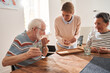 © Yakobchuk Olena - Friendly caregiver giving medicine for senior man and woman