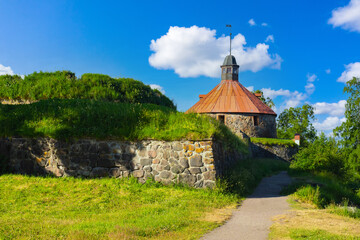 Wall Mural - Ancient fortress in Russia. Stone fortress in Karellia. Korela fortress on summer day. Stronghold Korela on background of blue sky. Landmark of Karelia. Ancient Russian Stronghold. Karelia tourism