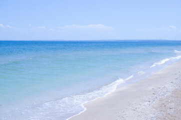 Sandy beach and the sea. Beautiful summer background. Design of photo wallpapers, screensavers, covers.