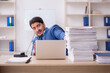© Elnur - Young male employee unhappy with excessive work in the office