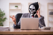 Devil Businessman Employee Sitting At Workplace