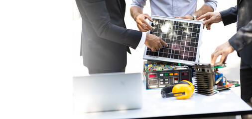 Hipster business man and Office building owner and energy engineer plan a project to build a solar panel for the building under construction. clean and green alternative energy concept.