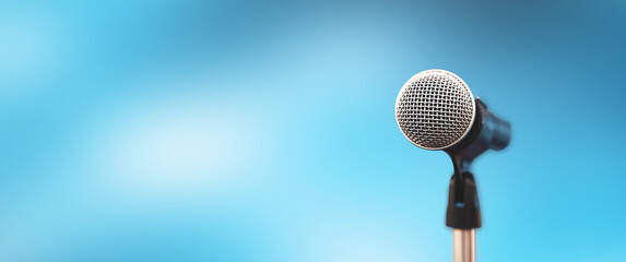 Microphone Public speaking backgrounds, Close-up the microphone on stand for speaker speech presentation stage performance with blur and bokeh light background.