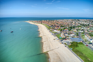 Wall Mural - East Beach in Selsey West Sussex with small boats lined up on the wide shingle beach. Aerial photo.