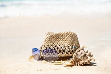 Wall Mural - Straw summer hat, sea shell and sunglasses on seaside shore, summer tropical holiday