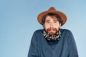 man with surprised expression wearing hat studio decoration hair care