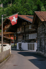 Wall Mural - Beautiful Traditional Timber Houses in a Picturesque Small Village in the Brienz Lake - the Swiss Alps - Iseltwald, Switzerland