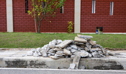 Wall Mural - A pile of concrete rubble near a brick wall.