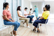 © Pornsak - Diverse people lining up waiting sit for their turn to get shots at the hospital vaccination center.
