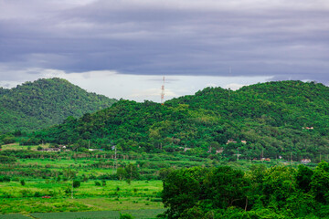 Wall Mural - Landscape mountain with green nature, Energy be friendly with environment concept, Power distribution pylon system to rural community and countryside